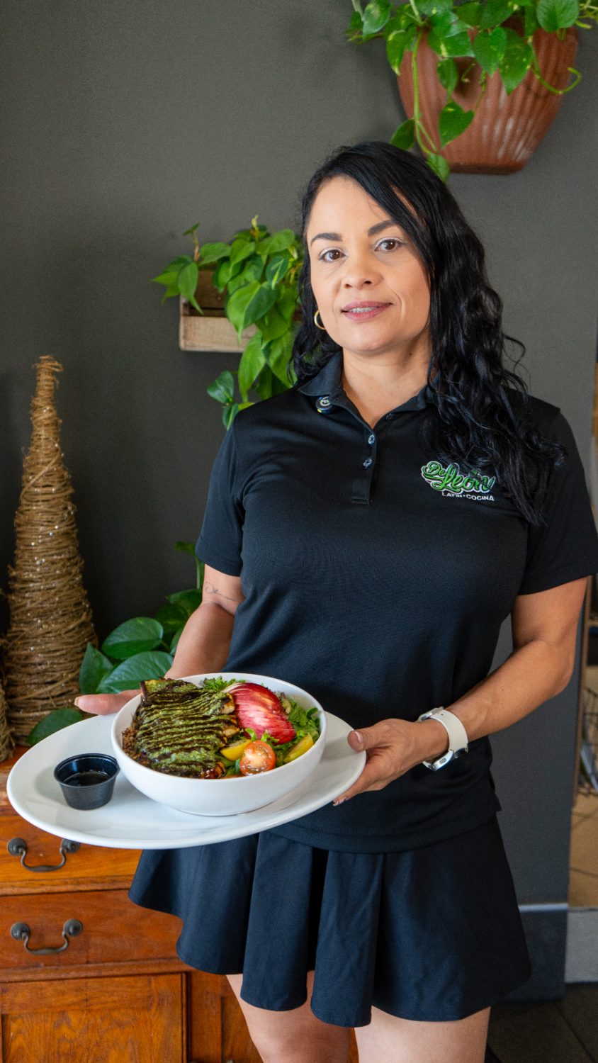 De León team member serving a fresh Colombian bowl